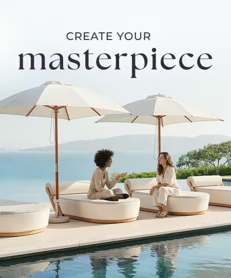 Two women relaxing on luxury daybeds beside an infinity pool with ocean views and large patio umbrellas.