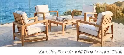 Four Kingsley Bate Amalfi teak lounge chairs gathered around a coffee table on a coastal oceanfront patio.